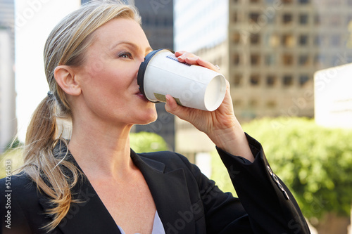 Photo: Businesswoman Drinking Takeaway Coffee Outside Office Businesswoman Drinking Takeaway Coffee Outside Office