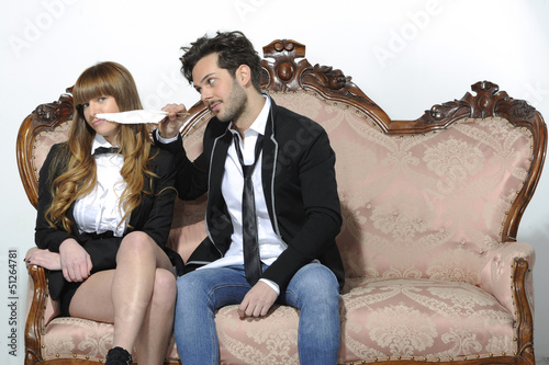 Photo: Engaged couple playing with feather Engaged couple playing with feather
