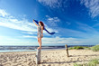 girl in striped dress on a beach