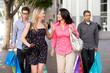 Foto: Two Couples With Bored Men Carrying Partners Bags Two Couples With Bored Men Carrying Partners Bags