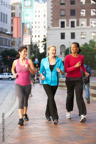 Photo: Group Of Women Power Walking On Urban Street Group Of Women Power Walking On Urban Street