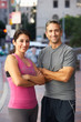 Portrait Of Male And Female Runners On Urban Street