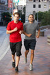 Two Men Running On Urban Street