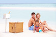 Photo: Family On Beach With Luxury Champagne Picnic Family On Beach With Luxury Champagne Picnic