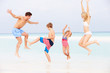 Photo: Family Having Fun In Sea On Beach Holiday Family Having Fun In Sea On Beach Holiday