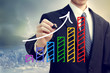 Businessman drawing a rising arrow