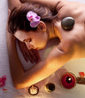 Foto: Woman getting stones spa procedures. Woman getting stones spa procedures.