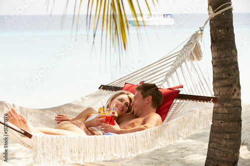 Photo: Romantic Couple Relaxing In Beach Hammock Romantic Couple Relaxing In Beach Hammock