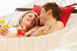 Romantic Couple Relaxing In Beach Hammock