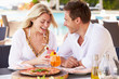 Photo: Couple Enjoying Meal In Outdoor Restaurant Couple Enjoying Meal In Outdoor Restaurant