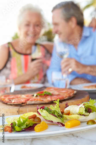 Photo: Senior Couple Enjoying Meal In Outdoor Restaurant Senior Couple Enjoying Meal In Outdoor Restaurant