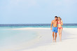 Photo: Romantic Couple Walking On Beautiful Tropical Beach Romantic Couple Walking On Beautiful Tropical Beach