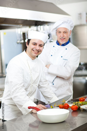 Photo: Portrait of two chefs in a restaurant kitchen Portrait of two chefs in a restaurant kitchen
