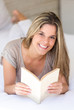 Woman at home reading a book