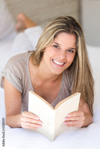 Photo: Woman at home reading a book Woman at home reading a book