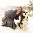 Photo: Happy young woman sitting with siberian husky dog Happy young woman sitting with siberian husky dog