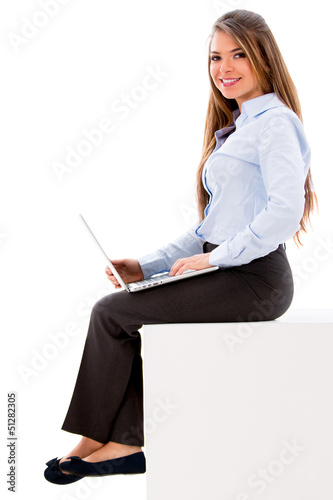 Photo: Business woman working on a laptop Business woman working on a laptop