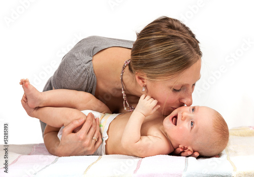Photo: Young Caucasian woman kissing her baby son Young Caucasian woman kissing her baby son