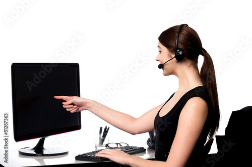 Photo: Female executive pointing at computer screen Female executive pointing at computer screen