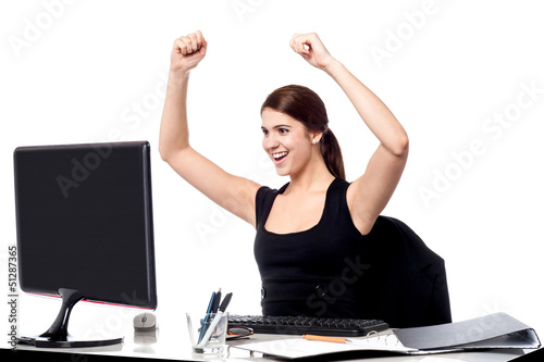 Photo: Excited business woman raising her hands. Excited business woman raising her hands.
