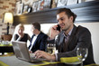 Photo: The businessman using the laptop and mobile in cafe. The businessman using the laptop and mobile in cafe.