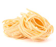 Italian pasta tagliatelle nest isolated on white background