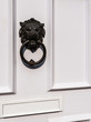 Closeup of a white front door with knocker