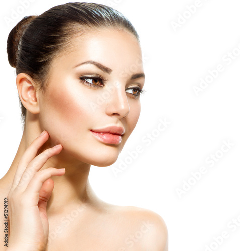 Photo: Beautiful Young Woman touching Her Skin. Portrait over White Beautiful Young Woman touching Her Skin. Portrait over White