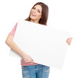 Photo: Casual young woman holding a white board Casual young woman holding a white board