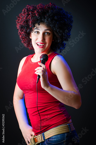 Photo: Female performer at disco with mic Female performer at disco with mic