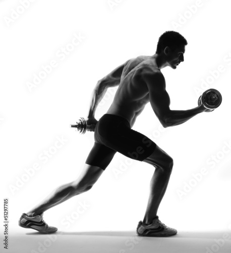 Photo: muscle model guy exercise over white background. muscle model guy exercise over white background.