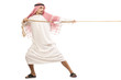 Foto: Arab man in tug of war concept Arab man in tug of war concept
