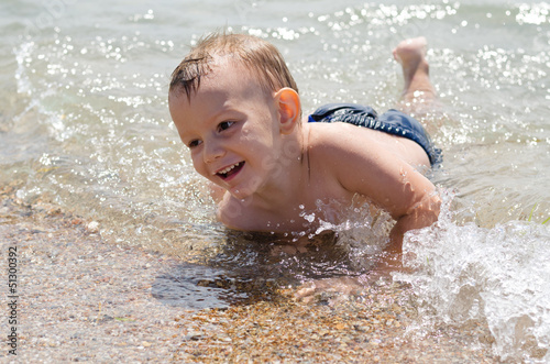 Photo: Cute little boy learning to swim Cute little boy learning to swim