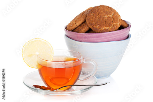 Photo: Glass cup of black tea with lemon and cookies Glass cup of black tea with lemon and cookies