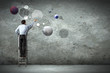 Business man drawing planets