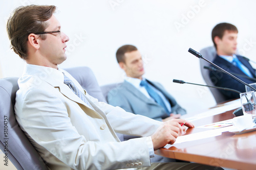 Photo: Three businesspeople at meeting Three businesspeople at meeting