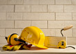 brick background, helmet and measuring tape