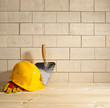brick background, trowel and helmet