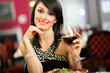 Foto: Woman tasting red wine in a restaurant Woman tasting red wine in a restaurant