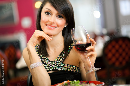 Photo: Woman tasting red wine in a restaurant Woman tasting red wine in a restaurant