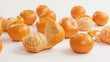 peeled tangerines on a white background
