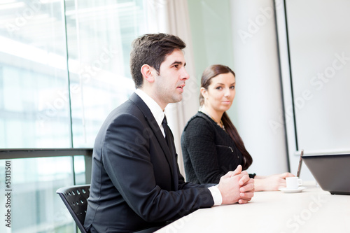 Photo: Happy business people in a meeting at office Happy business people in a meeting at office