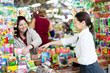 Foto: saleswoman and female byer with seeds saleswoman and female byer with seeds