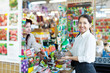 Foto: woman chooses solid fertilizer woman chooses solid fertilizer