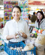 Smiling  woman buys garlic for planting