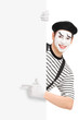 Mime artist pointing on a blank panel