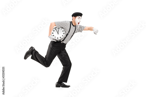 Photo: Full length portrait of a mime artist holding a clock and runnin Full length portrait of a mime artist holding a clock and runnin