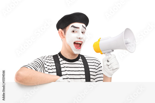Photo: Male mime artist holding a loudspeaker and posing on a blank pan Male mime artist holding a loudspeaker and posing on a blank pan