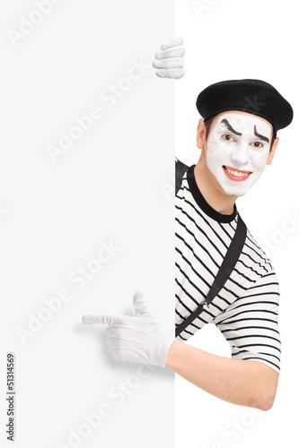 Photo: Mime artist pointing on a blank panel Mime artist pointing on a blank panel