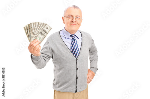 Photo: Smiling senior gentleman holding money Smiling senior gentleman holding money